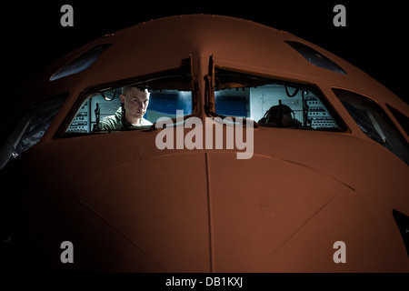 Aircrew members perform pre-flight checks on a C-17 Globemaster III before takeoff to practice combat on-loading and off-loading July 17, 2013, at Joint Base Charleston - Air Base, S.C. Airmen from the 437th Airlift Wing work around the clock on the fligh Stock Photo