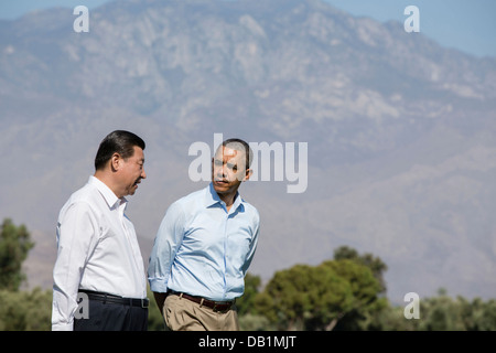 US President Barack Obama and President Xi Jinping of the People's Republic of China walk on the grounds of the Annenberg Retreat before their bilateral meeting at Sunnylands June 8, 2013 in Rancho Mirage, CA. Stock Photo