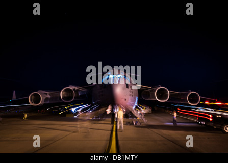 Aircrew members perform pre-flight checks on a C-17 Globemaster III before takeoff to practice combat on-loading and off-loading July 17, 2013, at Joint Base Charleston - Air Base, S.C. Airmen from the 437th Airlift Wing work around the clock on the fligh Stock Photo