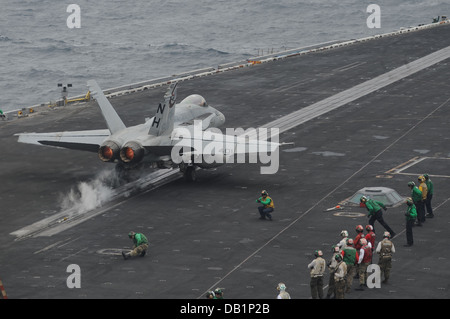 An F/A-18C Hornet assigned to the Death Rattlers of Marine Fighter Attack Squadron (VFA) 146 launches off of the flight deck of Stock Photo