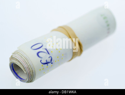 A Roll of Twenty Pound Notes held together with an Elastic Band. Stock Photo