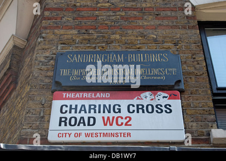 street name sign for charing cross road, london, england and, above, plaque marking the 1884 sandringham buildings Stock Photo