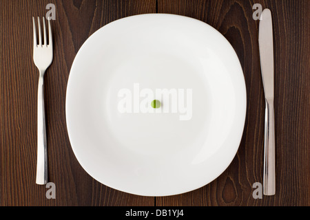 One pea on a white plate Stock Photo