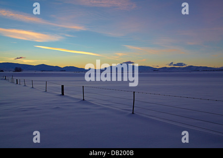 Sunset over snowy farmland near Oturehua, Maniototo, Central Otago, South Island, New Zealand Stock Photo