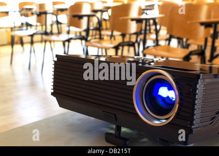 Turned on digital projector in a conference hall Stock Photo