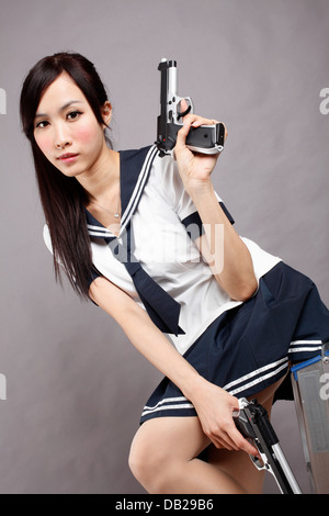 School girl plays gun. Stock Photo