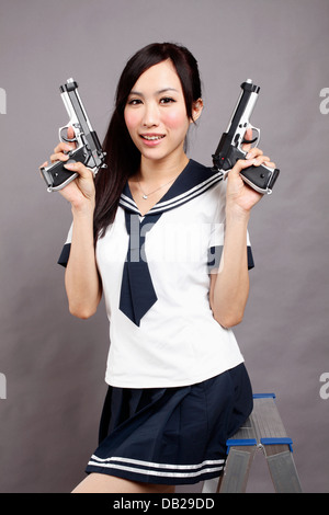 School girl plays gun. Stock Photo