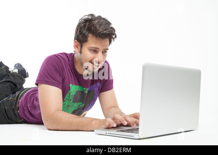Young male relaxed working on laptop Stock Photo