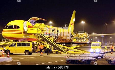 A Boeing 757 of German logistics group DHL is unloaded at the DHL hub of airport Leipzig/Halle, Germany, 17 December 2007. The state-of-the-art hub of DHL is about to reach its full capacity by spring 2008 with some 2,000 employees, 420 aircrafts and 32 flights per weekday. DHL Hub Leipzig GmbH managing director Norbert Viegers records 'Then, up to 100,000 parcels will be operated  Stock Photo