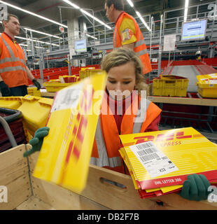 Employees of German logistics group DHL sort mail at the DHL hub of airport Leipzig/Halle, Germany, 17 December 2007. The state-of-the-art hub of DHL is about to reach its full capacity by spring 2008 with some 2,000 employees, 420 aircrafts and 32 flights per weekday. DHL Hub Leipzig GmbH managing director Norbert Viegers records 'Then, up to 100,000 parcels will be operated per h Stock Photo