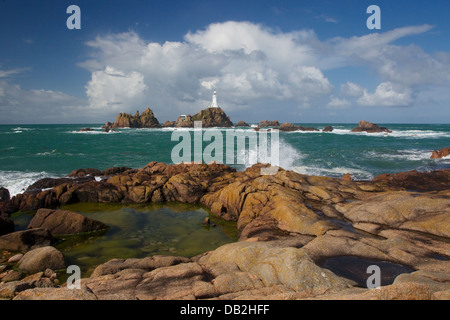 Rockpool with Corbiere Lighthouse in background Jersey Channel Islands, UK LA005941 Stock Photo