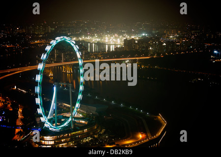 View of the Singapore Flyer, Tanjong Rhu and East Coast Parkway Expressway (ECP), from atop the Marina Bay Sands at Night Stock Photo