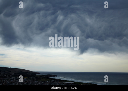Unusual storm clouds rolling in over St Kilda Beach, Dunedin, Otago, South Island, New Zealand Stock Photo