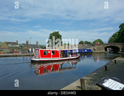 Linlithgow Union Canal society canal boat Victoria cruising on Union Canal past the berth at Linlithgow basin in Scotland Stock Photo