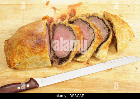 High angle view of a beef wellington or boeuf en crout cut into slices on a chopping board Stock Photo