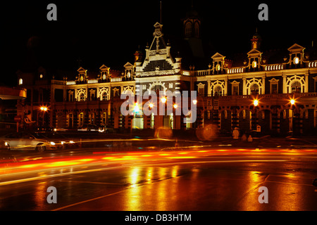 Historic Railway Station and traffic at night, Dunedin, South Island, New Zealand Stock Photo