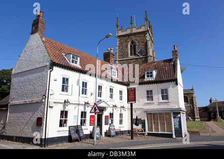 The George public house and church in Alford, Lincolnshire, England, U.K. Stock Photo