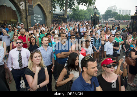 London, UK. Tuesday 23rd July 2013. Public and tourists watch the 62 gun salute at the Tower of London, to mark the birth of the Duke and Duchess of Cambridge's son. Filming the event on their smartphones and cameras. Credit:  Michael Kemp/Alamy Live News Stock Photo