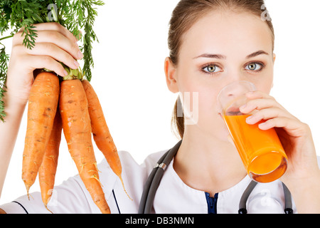 Female doctor holding healthy carrots and juice. Isolated on white. Stock Photo