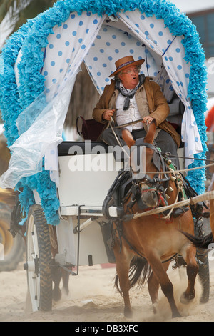 Catholic pilgrims traveling in horse-drawn wagons making the pilgrimage from Jerez to El Rocio in southern Spain Stock Photo