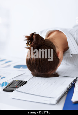 woman sleeping at work in funny pose Stock Photo
