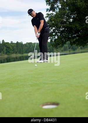 senior-citizen-playing-golf-dressed-in-black-action-shot-on-the-green-db4431.jpg