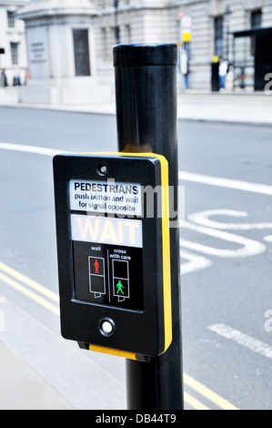 Push button at a pedestrian road crossing with traffic lights. Stock Photo