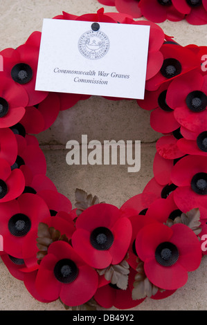 Close-up of circular poppy wreath laid by Commonwealth War Graves Commission (CWGC) at Stonefall Cemetery, Harrogate, North Yorkshire, England, UK. Stock Photo