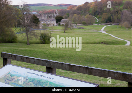 Scenic view over Bolton Abbey, Old Rectory & winding path seen from viewpoint & visitor information board to the south - Yorkshire Dales, England, UK. Stock Photo