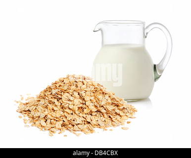 Glass jug with milk and cereal flakes on white background Stock Photo
