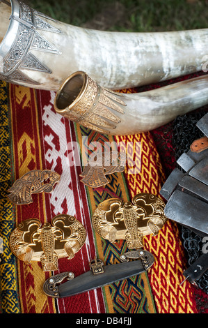 Anglo Saxon jewelry and drinking horns on a table at a historical re enactment Stock Photo