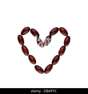 Coenzyme Q10 softgel capsules in the shape of a heart Stock Photo