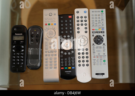 Remote controls for TV/ Sky/ DVD/ etc in a home Stock Photo