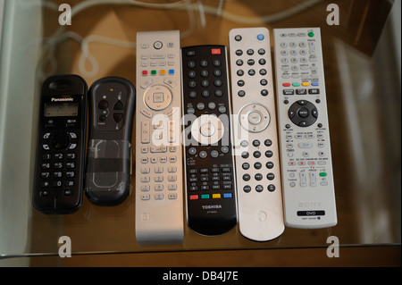 Remote controls for TV/ Sky/ DVD/ etc in a home Stock Photo