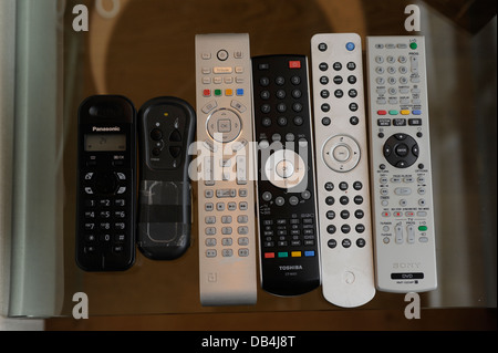 Remote controls for TV/ Sky/ DVD/ etc in a home Stock Photo