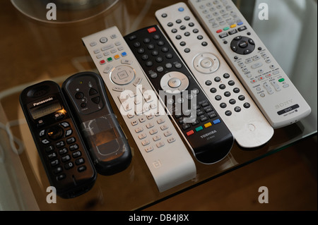 Remote controls for TV/ Sky/ DVD/ etc in a home Stock Photo