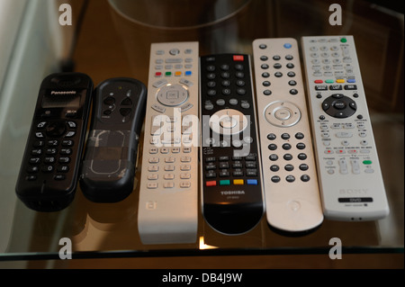 Remote controls for TV/ Sky/ DVD/ etc in a home Stock Photo