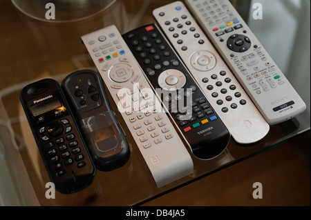 Remote controls for TV/ Sky/ DVD/ etc in a home Stock Photo