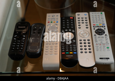 Remote controls for TV/ Sky/ DVD/ etc in a home Stock Photo