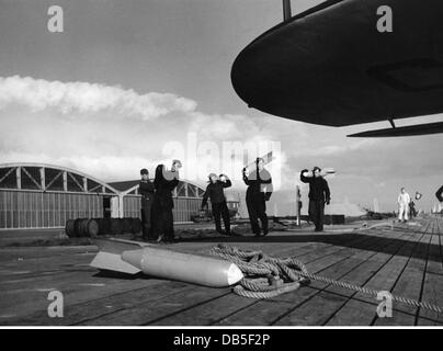 Nazism / National Socialism, military, Wehrmacht, Luftwaffe, soldiers of the Luftwaffe ground personnel carrying practice bombs, on a naval air base, Germany, circa 1940, Additional-Rights-Clearences-Not Available Stock Photo