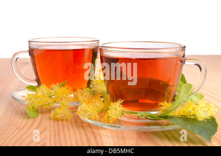 Two cups with herbal tea and linden flowers on a wooden background Stock Photo