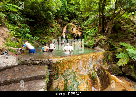 At Caldeira Velha people are bathing in a pool of warm water coming from a waterfall Stock Photo