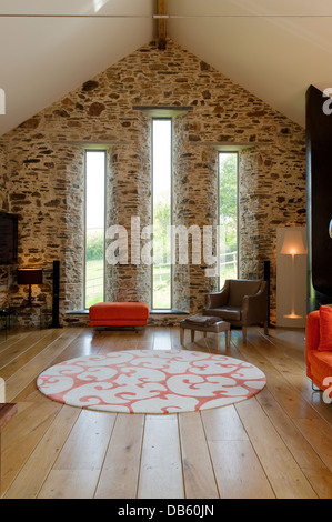Sparsely furnished mezzanine floor of 18th century Devon long barn conversion Stock Photo