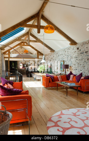 18th century Devon long barn conversion with L-shaped seating unit from Ikea on mezzanine floor Stock Photo