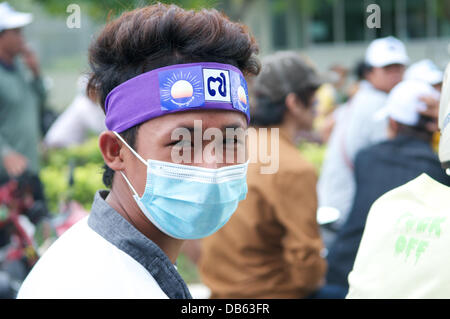 Phnom Penh, Cambodia on July 24th, 2013. portrait of a Sam Rainsy supporter in the audience. Sam Rainsy's party is the Cambodia National Rescue Party. Some Sam Rainsy supporters hide their faces w/ face masks in fear of retaliation from Hun Sen, the current prime minister & his government. Sam Rainsy has been in self-exile in France since 2009. he was granted a royal pardon from the King of Cambodia & returned to Cambodia on July 19th, 2013. Credit:  Kraig Lieb / Alamy Live News Stock Photo