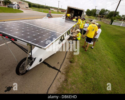 Mineral Wells, Texas, USA. 23rd July 2013. It's the third flat of the day doesn't discourage these high school students from Bullard High School they designed and built a three wheel solar powered car as the end product of a two year challenge. They hope to get to Los Angeles, Calif, on July 30st. Credit:  J. G. Domke/Alamy Live News Stock Photo