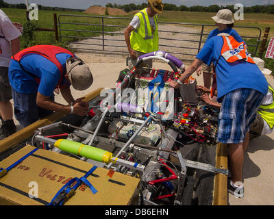 Forth Worth, Texas, USA. 23rd July 2013. Coming all the way from New York City - high school students try to figure out why the motor quit on their solar powered car. Students from Tottenville High School are challenged to build and safely race a roadworthy solar car Credit:  J. G. Domke/Alamy Live News Stock Photo