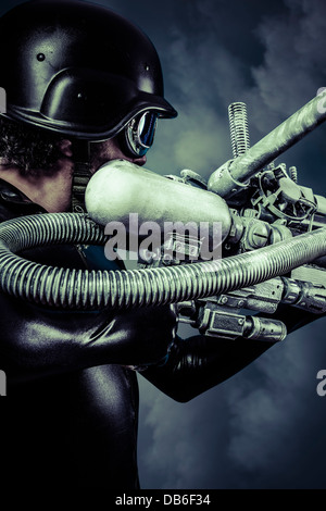 Warrior of the future with huge laser cannon shotgun over blue sky Stock Photo