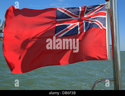 The UK Red Ensign as flown by merchant shipping and civil registered vessels flying from a British yacht. Stock Photo