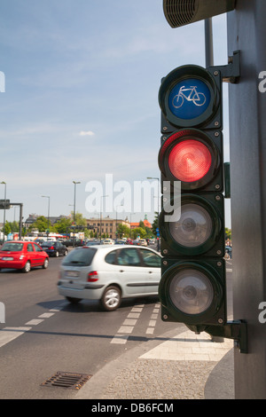 Traffic light for cyclists, bicycle light turns red and a car cross the cycle way Stock Photo